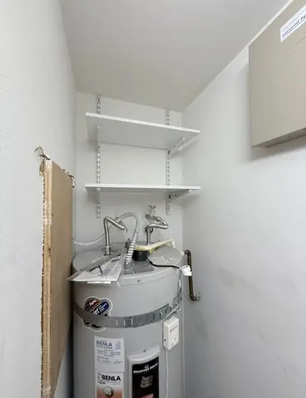 Adjustable white shelves installed above a water heater