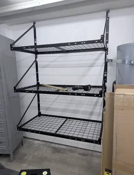 Three wall-mounted wire storage racks in a garage